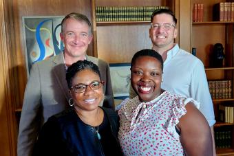2022 Harrington Fellows posing with UT Austin President Hartzell